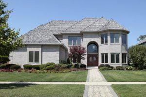 Light roof shingle color on Suburban home